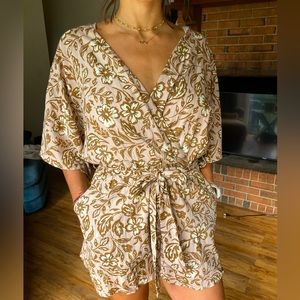 Never been worn, beautiful floral print romper with pockets.